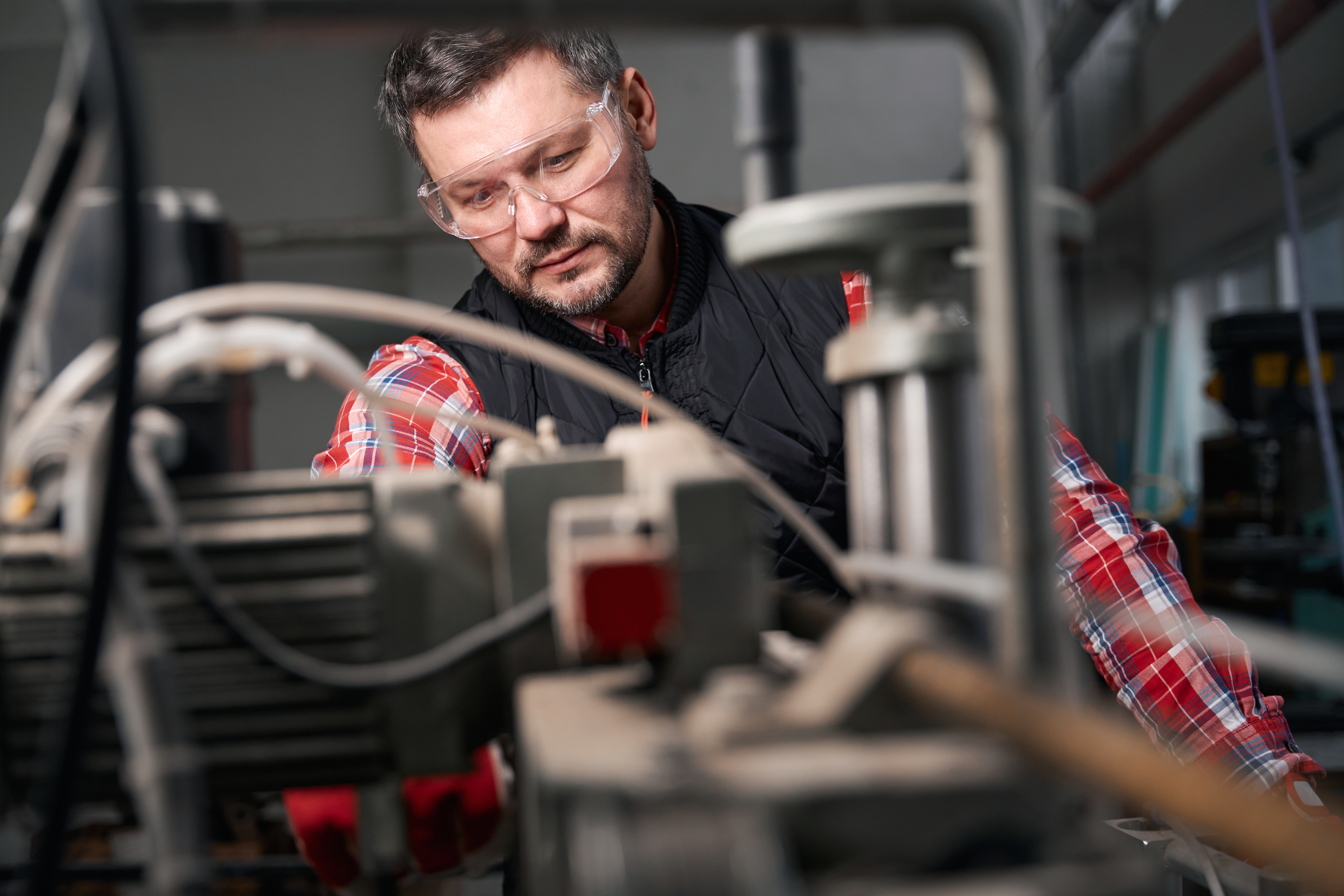 Adult worker processing metal structures, manufactures products